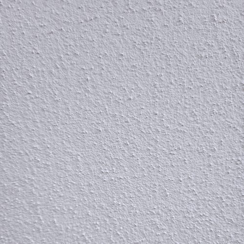 Nahaufnahme der weißen 0,7 mm Körnung eines Streich- und Rollputzes